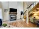Inviting living area featuring a fireplace, hardwood floors, natural light, and a staircase, creating a cozy atmosphere at 830 S Vance St # F, Lakewood, CO 80226