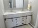 Bathroom features a modern double sink vanity with white countertops and stylish barn door cabinet at 9887 E Peakview Ave # F06, Englewood, CO 80111