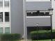 The apartment building with gray siding and trimmed bushes at 9887 E Peakview Ave # F06, Englewood, CO 80111