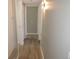 Hallway showing wood-look flooring and multiple doors to different areas of the home at 9887 E Peakview Ave # F06, Englewood, CO 80111