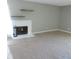 Comfortable living room featuring a cozy fireplace and floating shelves at 9887 E Peakview Ave # F06, Englewood, CO 80111
