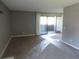 Bright living area with sliding glass doors offering access to an outdoor balcony at 9887 E Peakview Ave # F06, Englewood, CO 80111