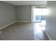 Bright living room has sliding doors to an outdoor balcony and neutral walls at 9887 E Peakview Ave # F06, Englewood, CO 80111