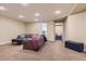Finished basement offers a large open space, carpeted floors, and neutral paint at 10935 Valleybrook Cir, Highlands Ranch, CO 80130