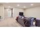 Finished basement features a living room area, TV, and neutral paint at 10935 Valleybrook Cir, Highlands Ranch, CO 80130