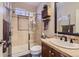 Bathroom featuring tiled walk-in shower, wooden vanity, and neutral color palette at 10935 Valleybrook Cir, Highlands Ranch, CO 80130
