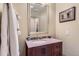 Bathroom with granite counters, dark wood cabinets, decorative mirror and a bathtub shower combo at 10935 Valleybrook Cir, Highlands Ranch, CO 80130