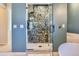 Luxurious shower with unique tile design and glass door in a modern bathroom at 10935 Valleybrook Cir, Highlands Ranch, CO 80130