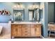 Stylish bathroom with double vanity, wood cabinets, modern mirrors, and unique wall decor at 10935 Valleybrook Cir, Highlands Ranch, CO 80130