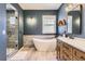 Elegant bathroom with soaking tub, walk-in shower, and modern fixtures and lighting at 10935 Valleybrook Cir, Highlands Ranch, CO 80130