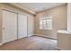 Bedroom features carpet flooring, neutral walls, large closet, and natural light from the window at 10935 Valleybrook Cir, Highlands Ranch, CO 80130