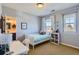 Bright bedroom with a desk, a twin bed and a view of a bathroom through the doorway at 10935 Valleybrook Cir, Highlands Ranch, CO 80130