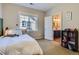 Cozy bedroom includes an ensuite bathroom, carpet, and natural light at 10935 Valleybrook Cir, Highlands Ranch, CO 80130