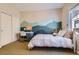 Bedroom features a mountain mural accent wall, plush carpet, and closet at 10935 Valleybrook Cir, Highlands Ranch, CO 80130