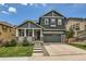 Charming two-story home boasts a well-maintained lawn and a welcoming front porch with stone accents at 10935 Valleybrook Cir, Highlands Ranch, CO 80130