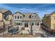 This is the exterior back elevation of this two story home at 10935 Valleybrook Cir, Highlands Ranch, CO 80130