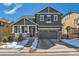 Charming two-story home with stone accents, covered porch, and attached two-car garage at 10935 Valleybrook Cir, Highlands Ranch, CO 80130