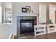 Cozy fireplace with decorative mantle, tiled hearth, and views to the exterior beyond at 10935 Valleybrook Cir, Highlands Ranch, CO 80130