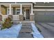 Charming home entrance with stone accents, covered porch, and a two-car garage at 10935 Valleybrook Cir, Highlands Ranch, CO 80130