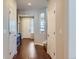 Bright hallway with hardwood floors leading to the front door, showcasing neutral wall paint and white doors at 10935 Valleybrook Cir, Highlands Ranch, CO 80130