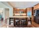 Kitchen featuring stainless steel appliances, a large island, granite countertops and barstool seating at 10935 Valleybrook Cir, Highlands Ranch, CO 80130
