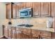 Well-equipped kitchen with stainless steel microwave, gas cooktop, granite countertops, and plenty of cabinet space at 10935 Valleybrook Cir, Highlands Ranch, CO 80130