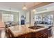 Bright kitchen featuring granite countertops, pendant lighting, and a seamless flow into the dining and living areas at 10935 Valleybrook Cir, Highlands Ranch, CO 80130