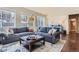 Bright living room boasts a large sectional sofa, stylish ottoman, and plenty of natural light at 10935 Valleybrook Cir, Highlands Ranch, CO 80130