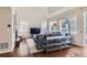 Comfortable living room featuring hardwood floors, a vaulted ceiling, and large windows for abundant natural light at 10935 Valleybrook Cir, Highlands Ranch, CO 80130