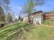 Green backyard featuring a sloped lawn, mature trees, and a gazebo, creating a tranquil outdoor space at 6863 S Detroit Cir, Centennial, CO 80122