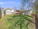 Lush backyard with well-maintained lawn, mature trees, and a charming gazebo, perfect for relaxation at 6863 S Detroit Cir, Centennial, CO 80122