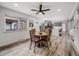 Bright dining room with wood floors, a modern ceiling fan, and an open view to the kitchen at 6863 S Detroit Cir, Centennial, CO 80122