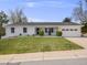 Daytime shot of a charming, updated home with a freshly painted exterior and manicured front yard at 6863 S Detroit Cir, Centennial, CO 80122