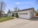 Well-maintained white brick home featuring a spacious driveway, attached garage, and manicured front lawn at 6863 S Detroit Cir, Centennial, CO 80122