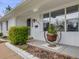Up close image of a charming home with a decorative plant hanger by the front door at 6863 S Detroit Cir, Centennial, CO 80122