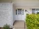 Charming front entrance featuring a white door with side windows, a decorative light fixture, and green bushes at 6863 S Detroit Cir, Centennial, CO 80122