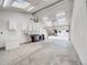 Large garage interior with skylights, workspace, and storage, offering ample room for projects and parking at 6863 S Detroit Cir, Centennial, CO 80122