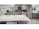 Modern kitchen with gray cabinets, stainless steel appliances, and a large quartz island at 6863 S Detroit Cir, Centennial, CO 80122