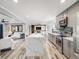 Open-concept kitchen featuring stainless steel appliances, quartz countertops, and hardwood floors at 6863 S Detroit Cir, Centennial, CO 80122