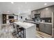 Open-concept kitchen featuring a large island with seating, stainless steel appliances, and modern finishes at 6863 S Detroit Cir, Centennial, CO 80122