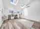 Bright living room with skylights, wood floors, and white walls at 6863 S Detroit Cir, Centennial, CO 80122