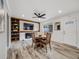 Cozy living room with a fireplace, built-in shelving, and a dining area at 6863 S Detroit Cir, Centennial, CO 80122