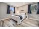 Relaxing main bedroom with wood floors, soft lighting, and a serene color scheme at 6863 S Detroit Cir, Centennial, CO 80122