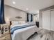 Relaxing main bedroom with wood floors, soft lighting, and a serene color scheme at 6863 S Detroit Cir, Centennial, CO 80122