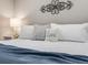 Close-up of bed featuring white bedding, decorative pillows, and a 'Love' throw pillow at 6863 S Detroit Cir, Centennial, CO 80122