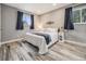 Relaxing main bedroom with wood floors, soft lighting, and a serene color scheme at 6863 S Detroit Cir, Centennial, CO 80122