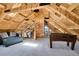 Attic space featuring wood-paneled walls, foosball table, and skylight for natural light at 10268 Christopher Dr, Conifer, CO 80433