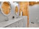 Charming bathroom features double sinks, white vanities, and textured tile accents at 10268 Christopher Dr, Conifer, CO 80433