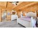 Charming bedroom includes ensuite bathroom, plush carpet, and a bright, welcoming ambiance at 10268 Christopher Dr, Conifer, CO 80433