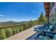 Expansive deck offers comfortable seating with stunning panoramic views of the surrounding forest at 10268 Christopher Dr, Conifer, CO 80433